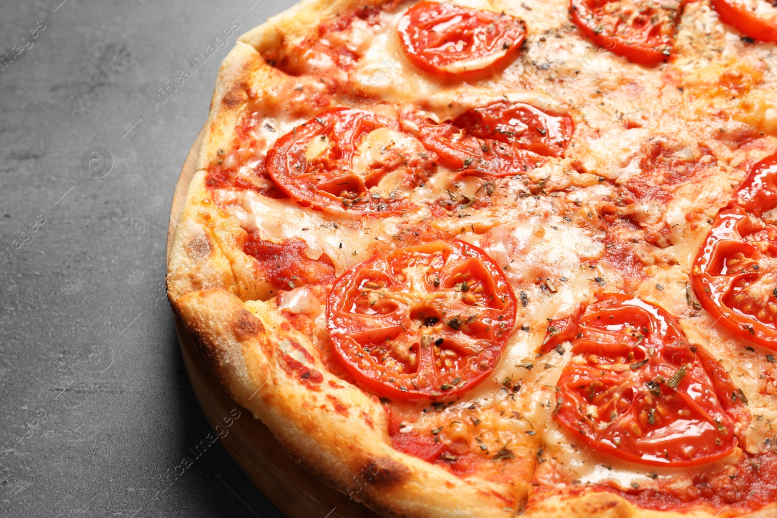 Photo of Hot cheese pizza Margherita on grey background, closeup