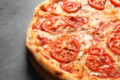 Hot cheese pizza Margherita on grey background, closeup