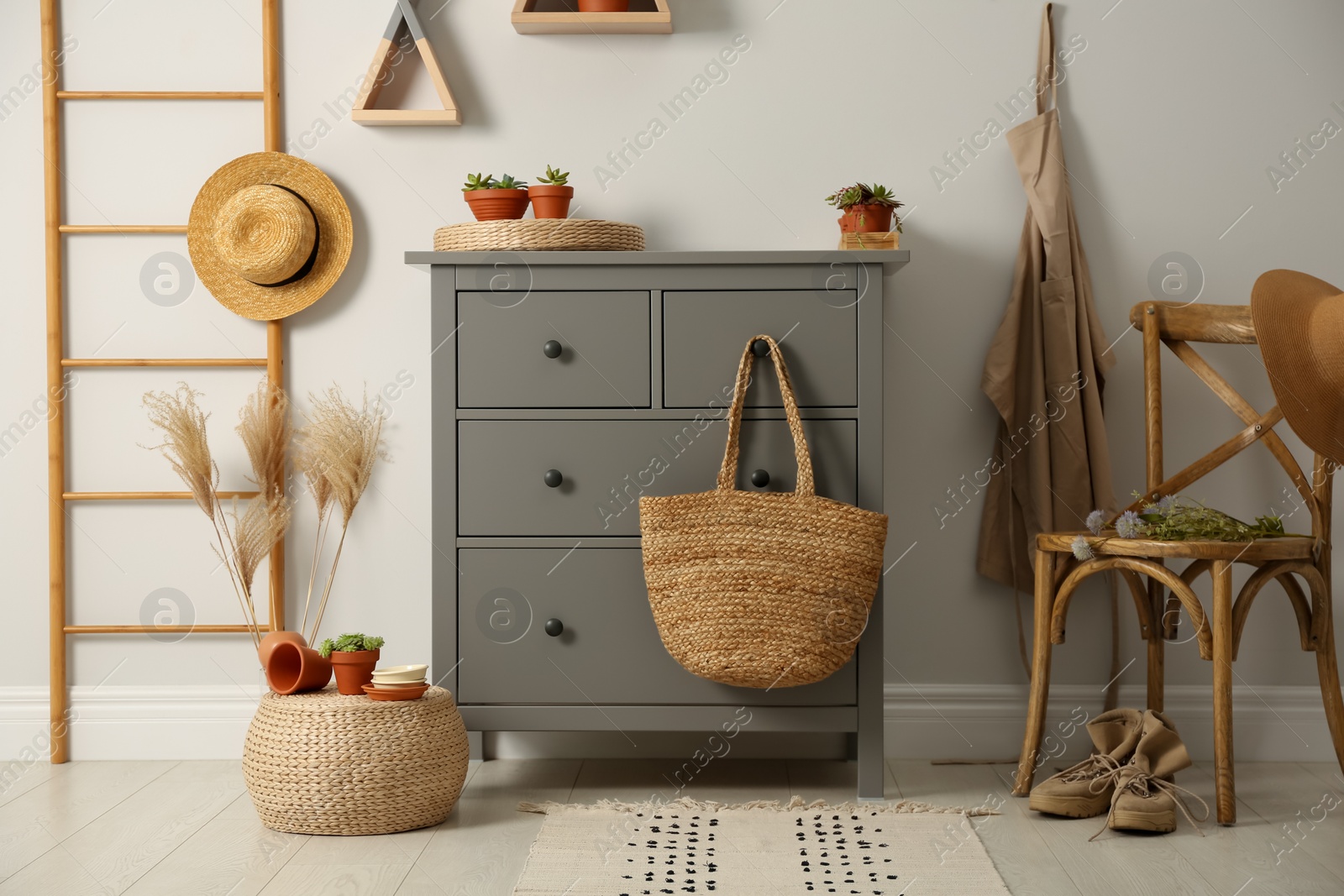 Photo of Grey chest of drawers in stylish room interior