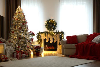 Stylish room interior with fireplace and beautiful Christmas tree