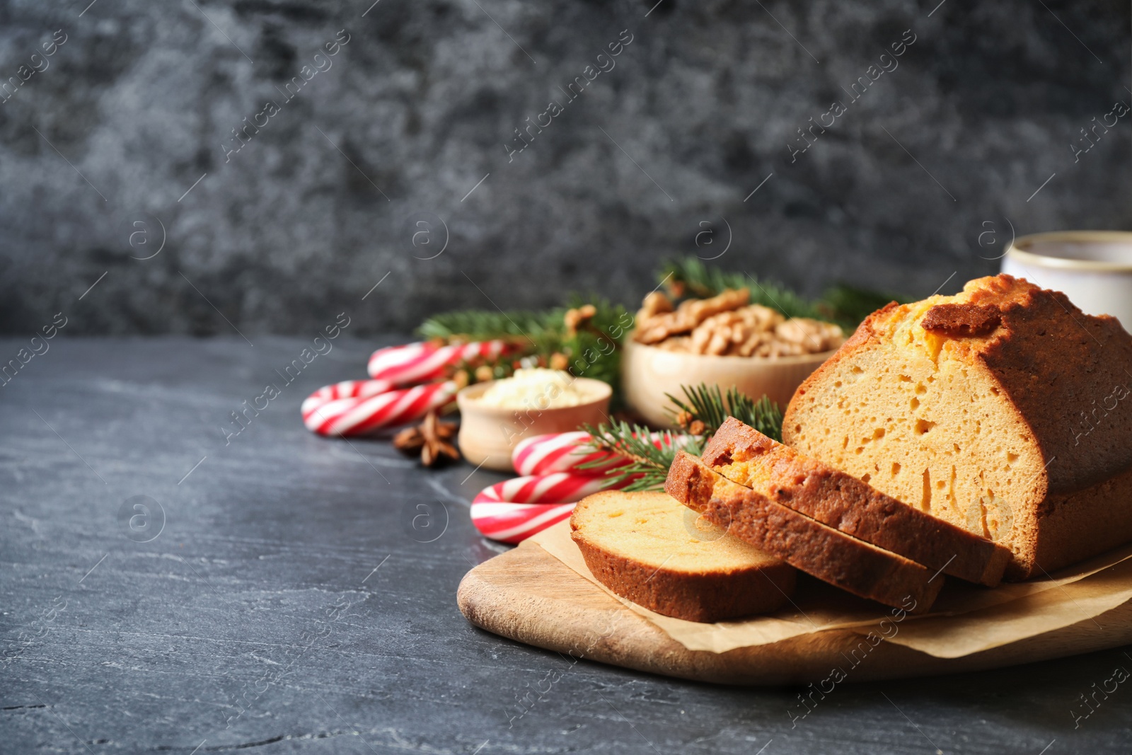 Photo of Fresh sliced gingerbread cake on grey table, space for text