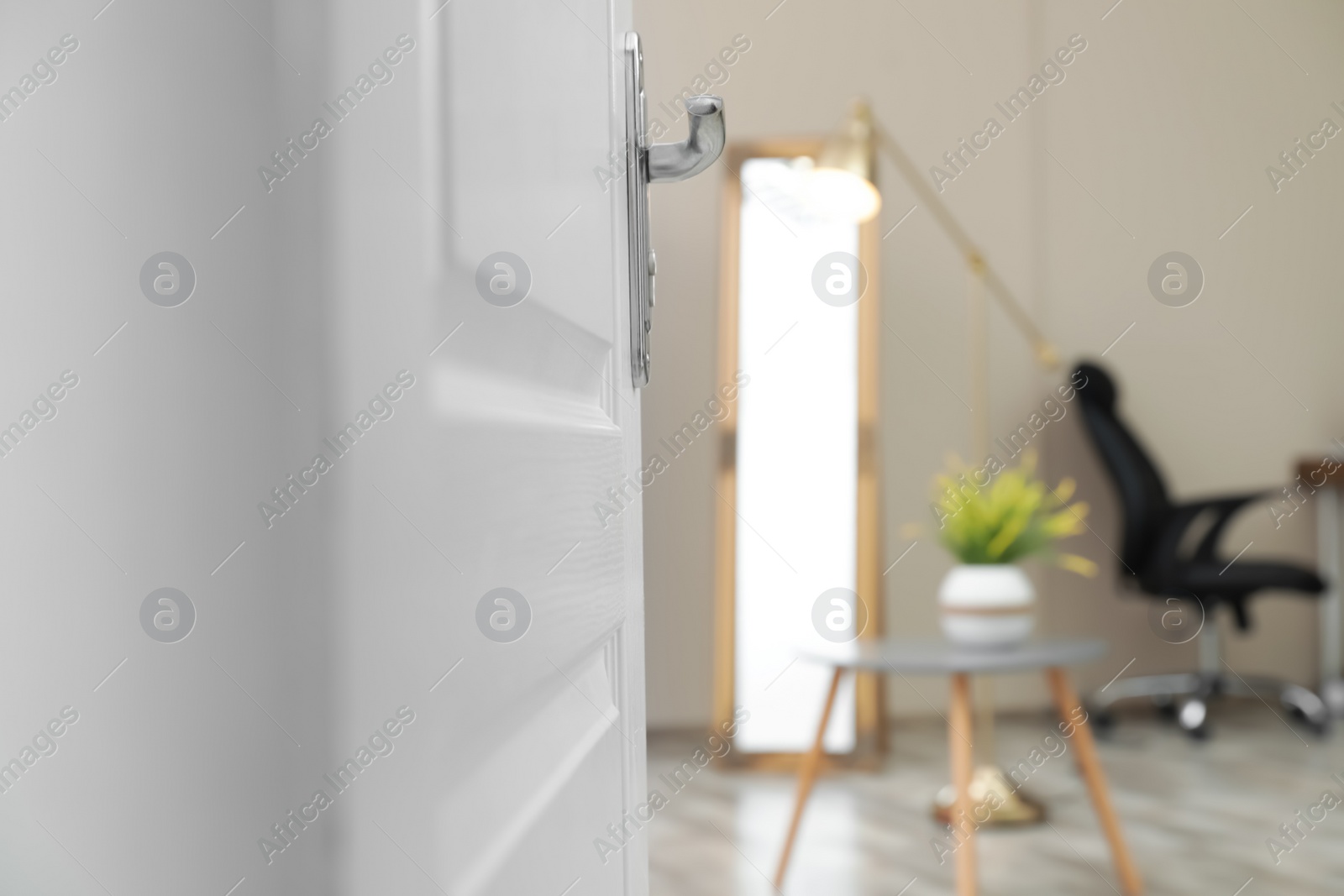 Photo of Stylish room interior, view through open door