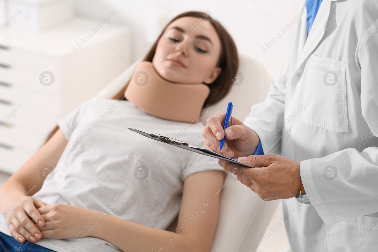 Photo of Doctor filling patient's medical card in clinic, closeup