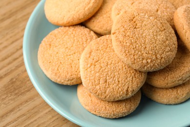 Photo of Delicious sugar cookies on wooden table, closeup