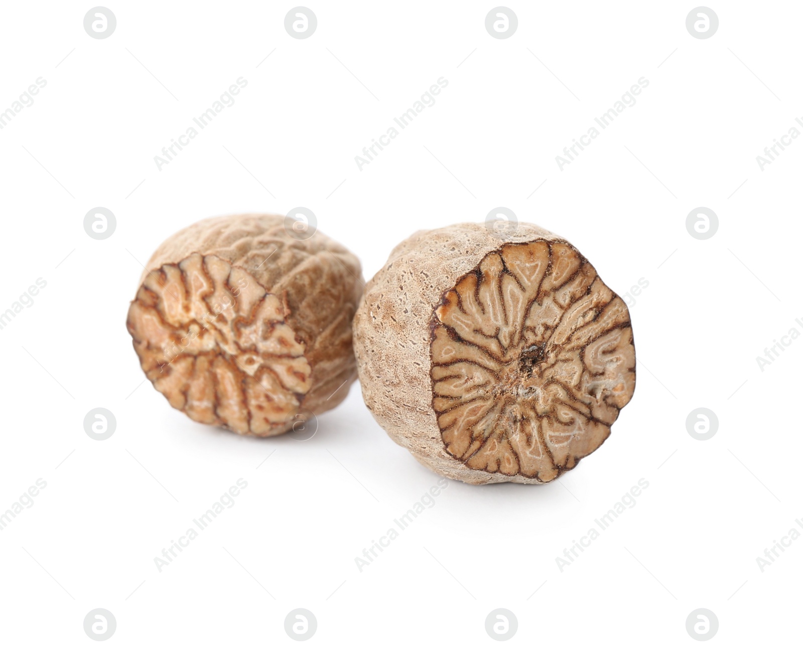 Photo of Pieces of nutmeg seeds isolated on white