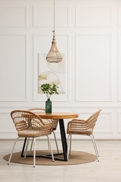 Dining room interior with comfortable furniture and green branches