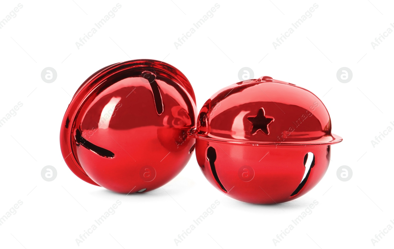 Photo of Shiny red sleigh bells on white background