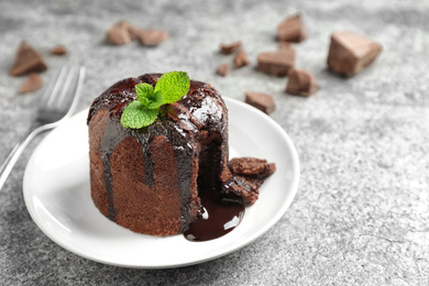 Delicious warm chocolate lava cake on grey table