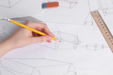 Photo of Woman creating packaging design at table, top view