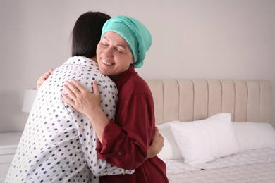 Young woman visiting her mother with cancer indoors