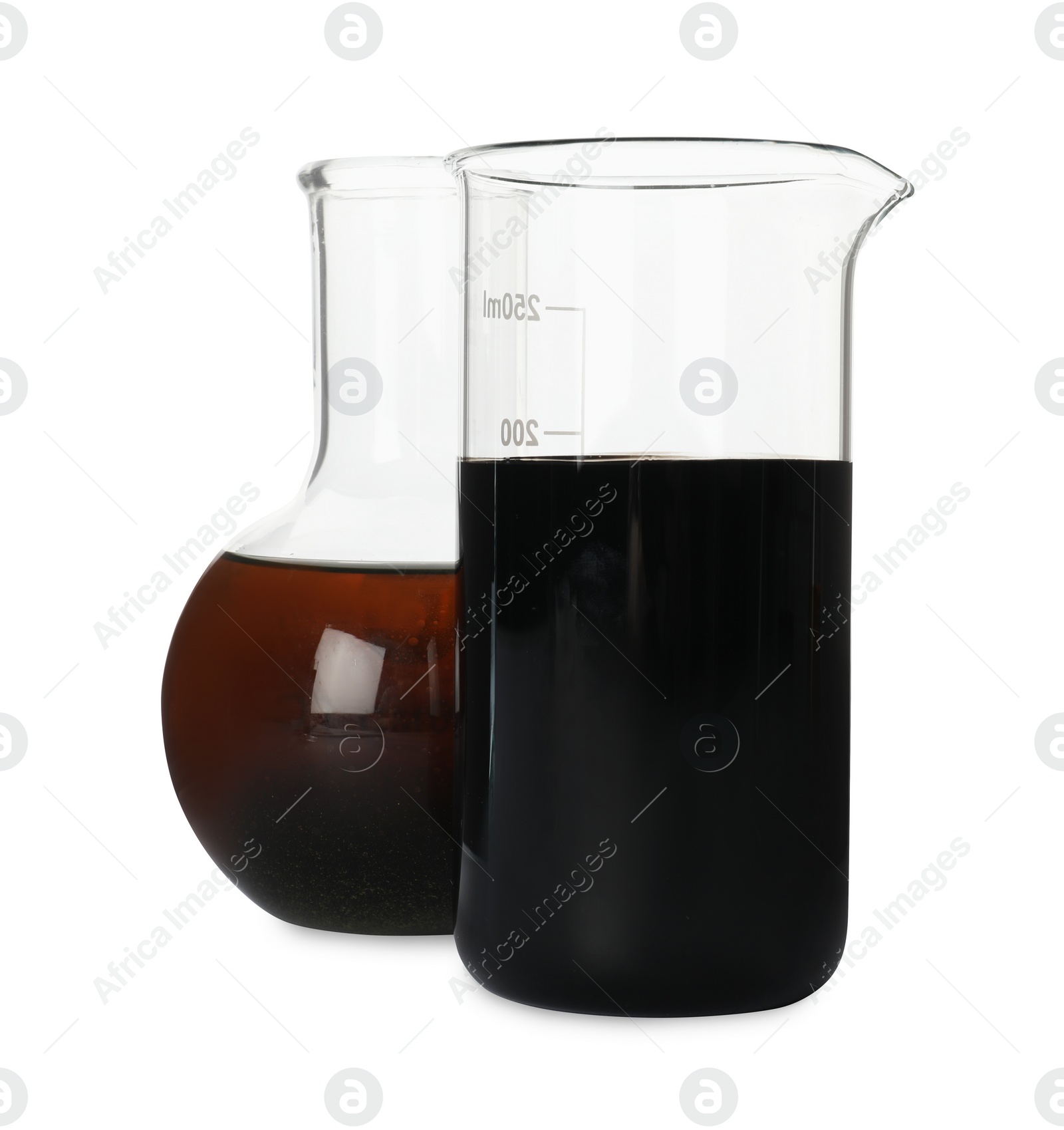 Photo of Beaker and flask with different types of crude oil isolated on white