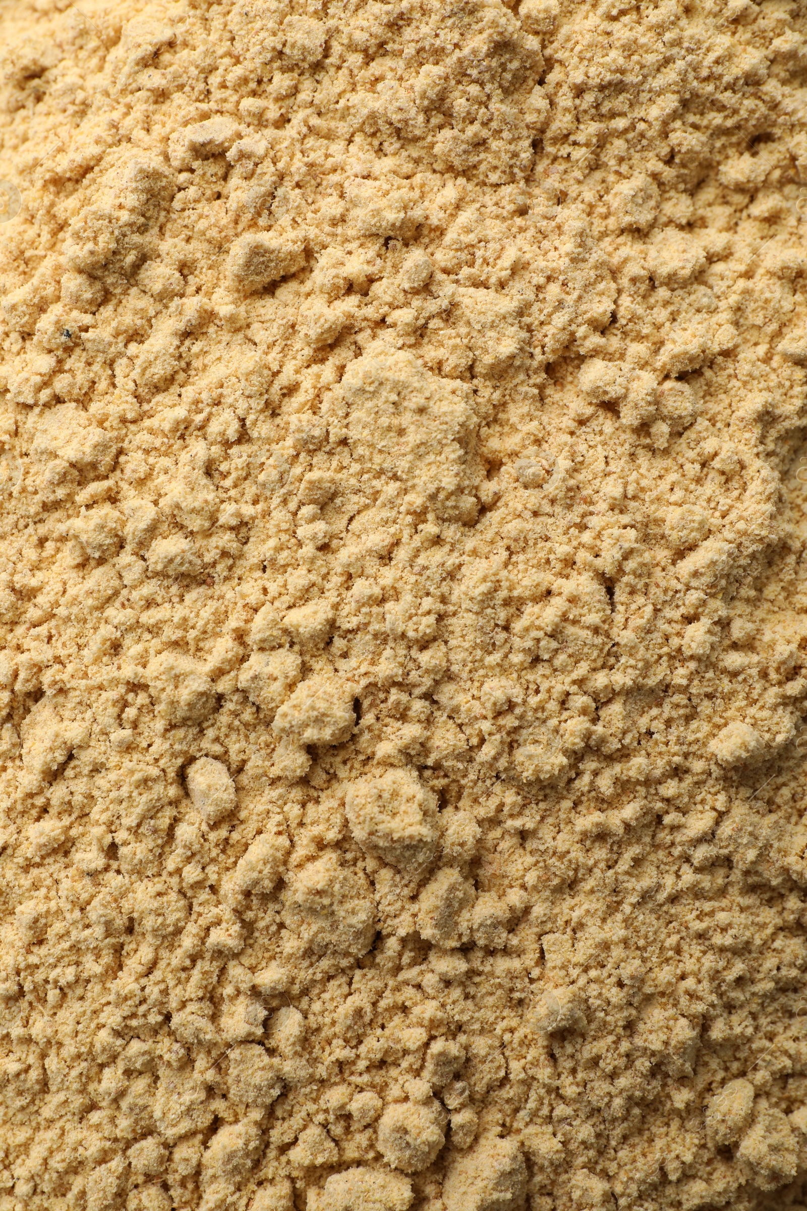 Photo of Aromatic mustard powder as background, top view