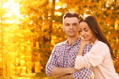 Happy couple in sunny park. Autumn walk