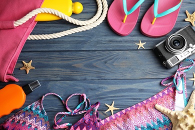 Photo of Flat lay composition with beach objects on blue wooden background. Space for text