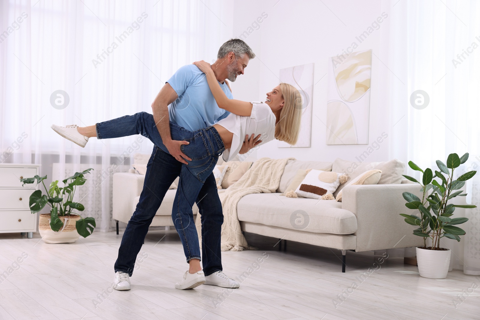 Photo of Happy affectionate couple dancing at home, space for text. Romantic date