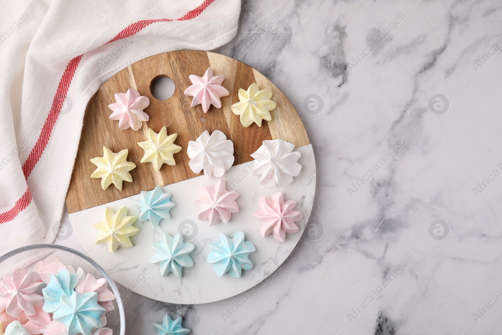 Photo of Tray with tasty meringue cookies on white marble table, top view. Space for text