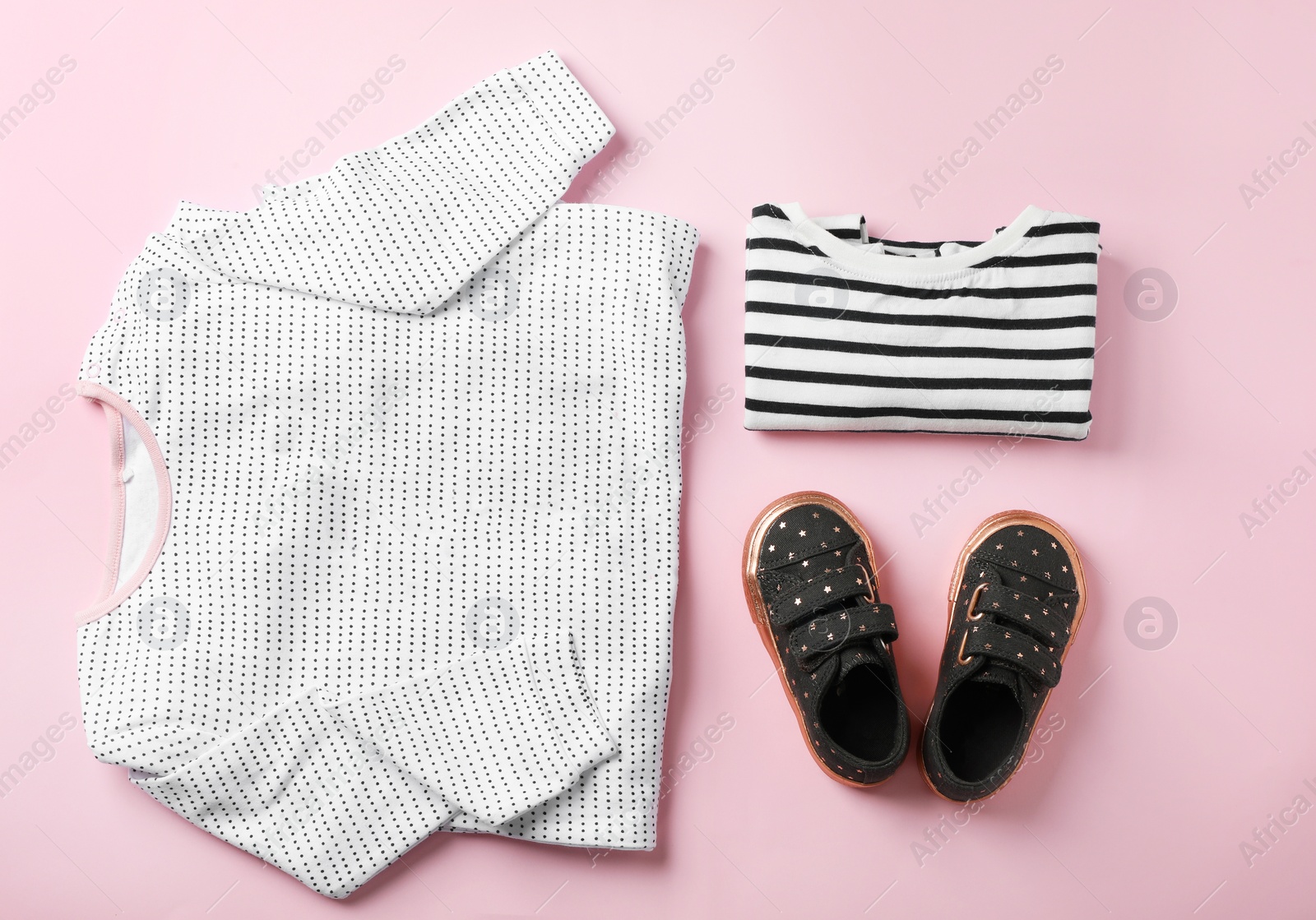 Photo of Flat lay composition with cute child clothes and shoes on color background