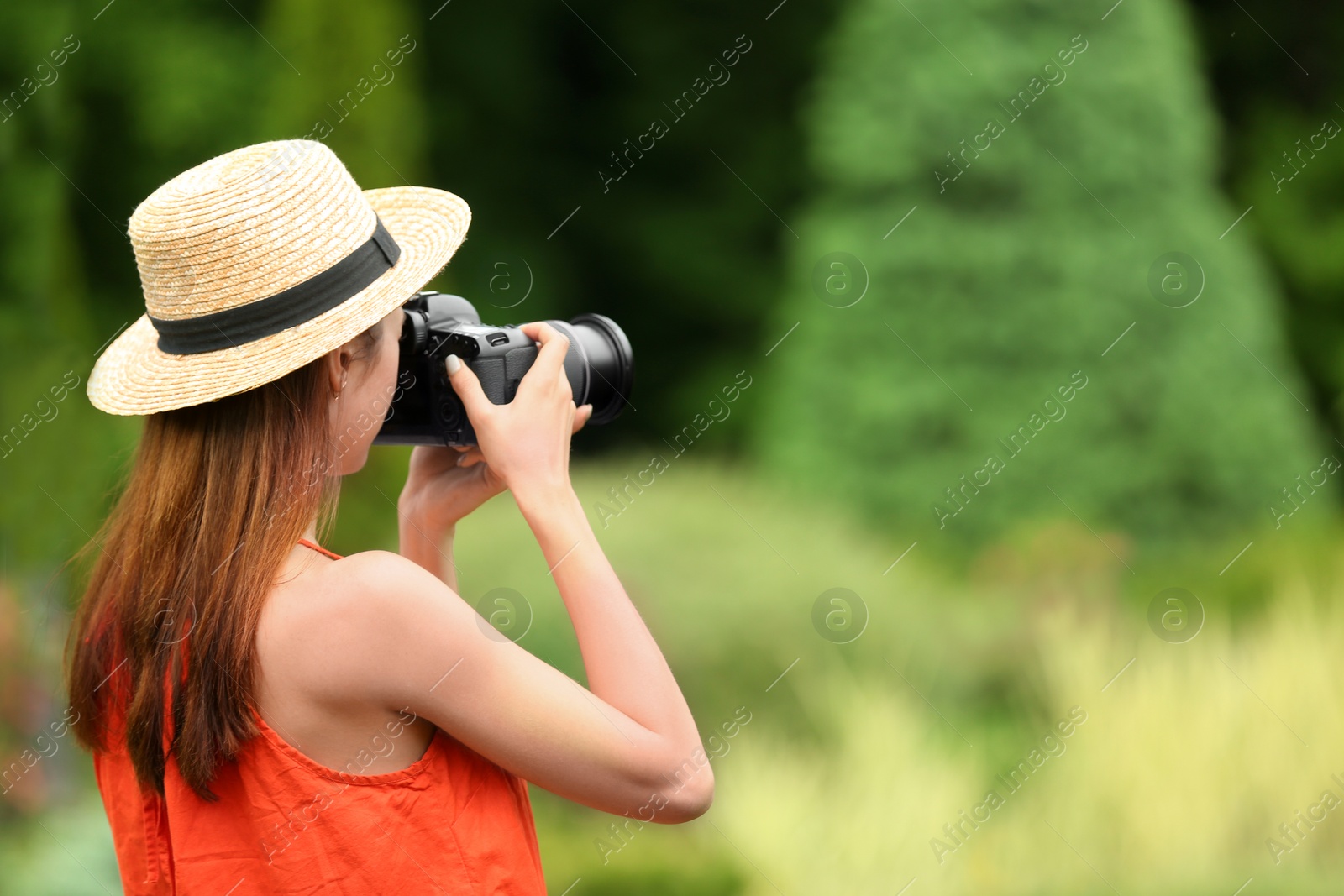 Photo of Photographer taking photo with professional camera in park