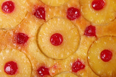 Photo of Tasty pineapple cake with cherries as background, top view