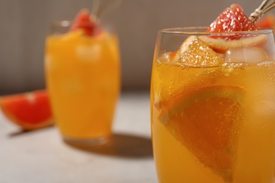 Delicious orange soda water on light background, closeup