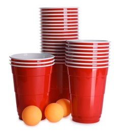 Photo of Plastic cups and balls for beer pong on white background