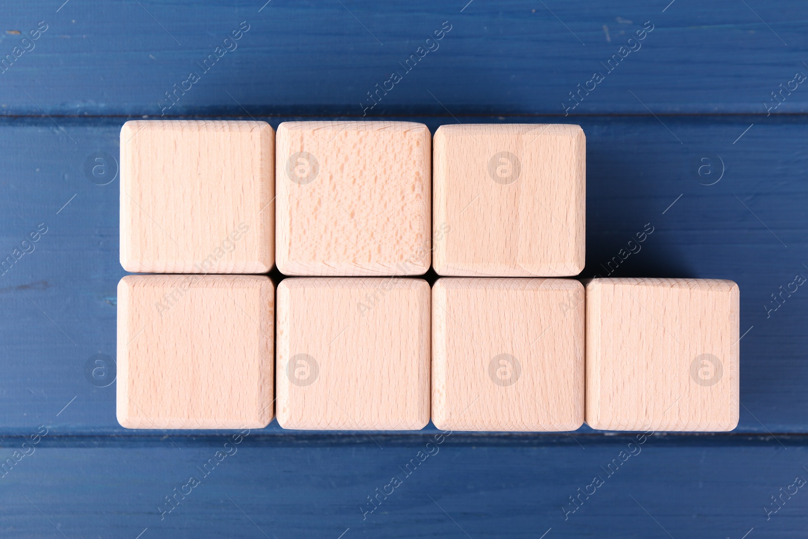 Photo of International Organization for Standardization. Cubes with abbreviation ISO and number 9001 on blue wooden table, flat lay