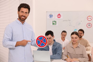 Teacher showing No Stopping road sign during lesson in driving school