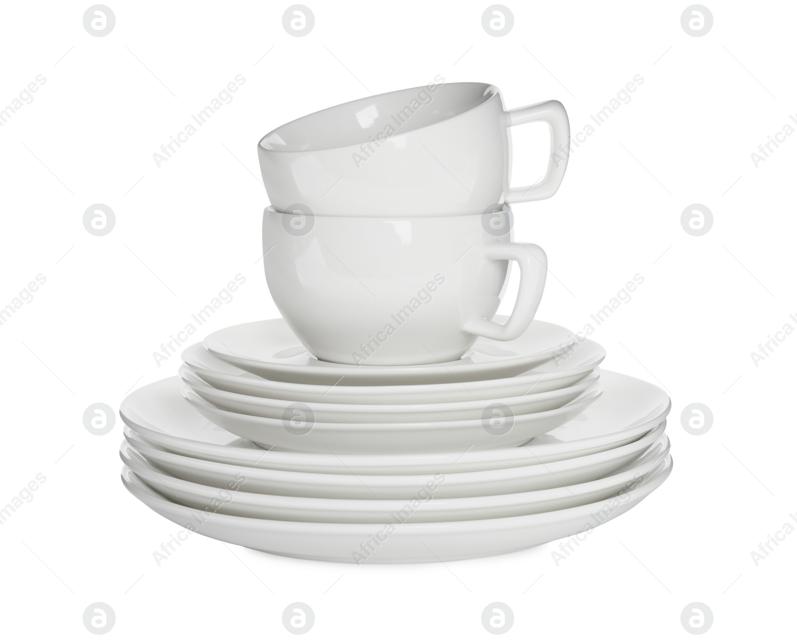 Photo of Stacked plates and cups on white background