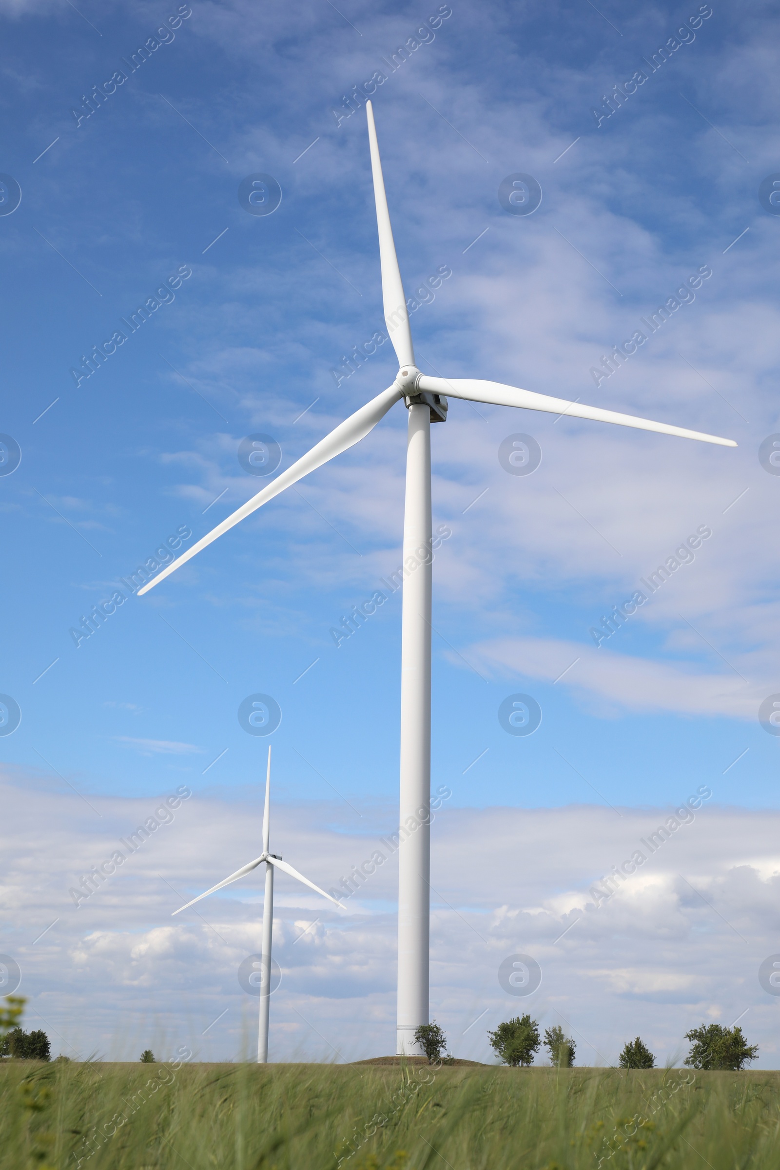 Photo of Beautiful view of field with wind turbines. Alternative energy source