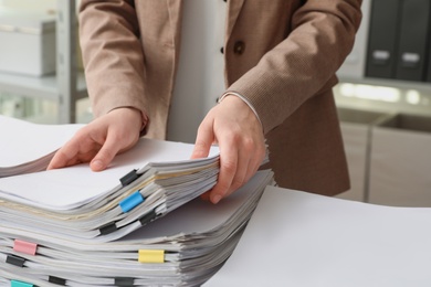 Photo of Woman working with documents in office, closeup