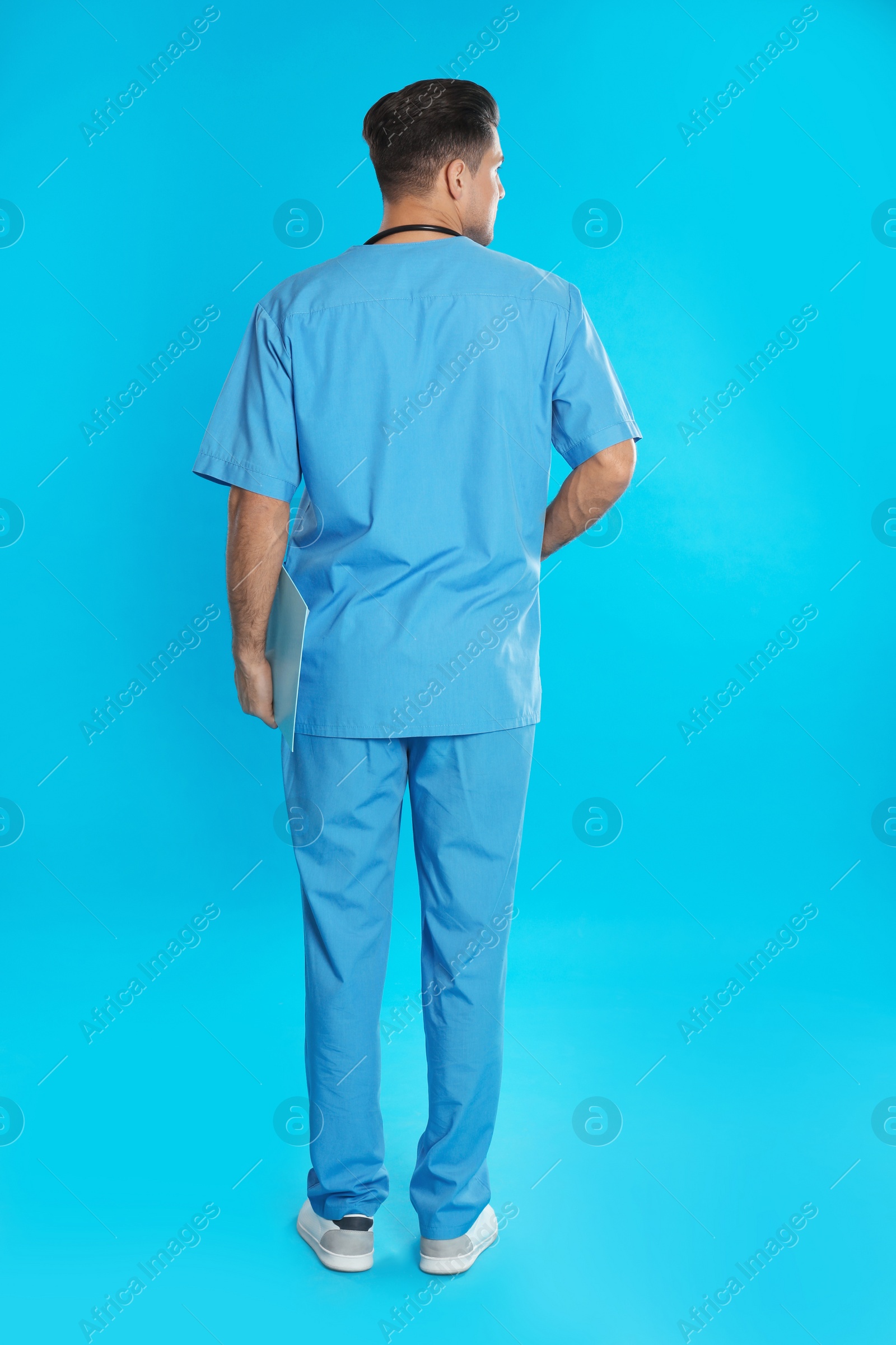 Photo of Doctor in clean uniform on blue background