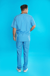 Doctor in clean uniform on blue background