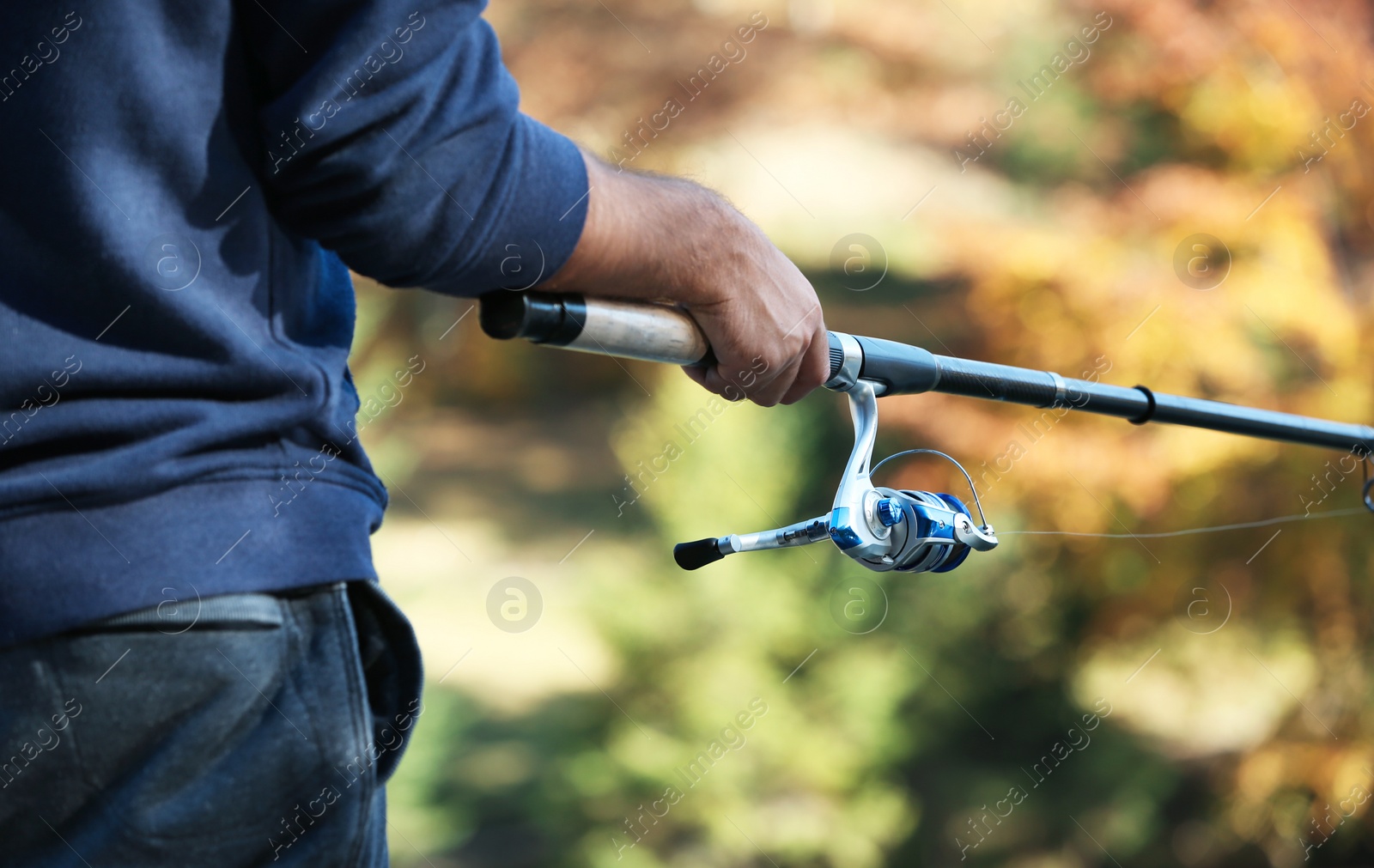 Photo of Man fishing alone on blurred background, closeup