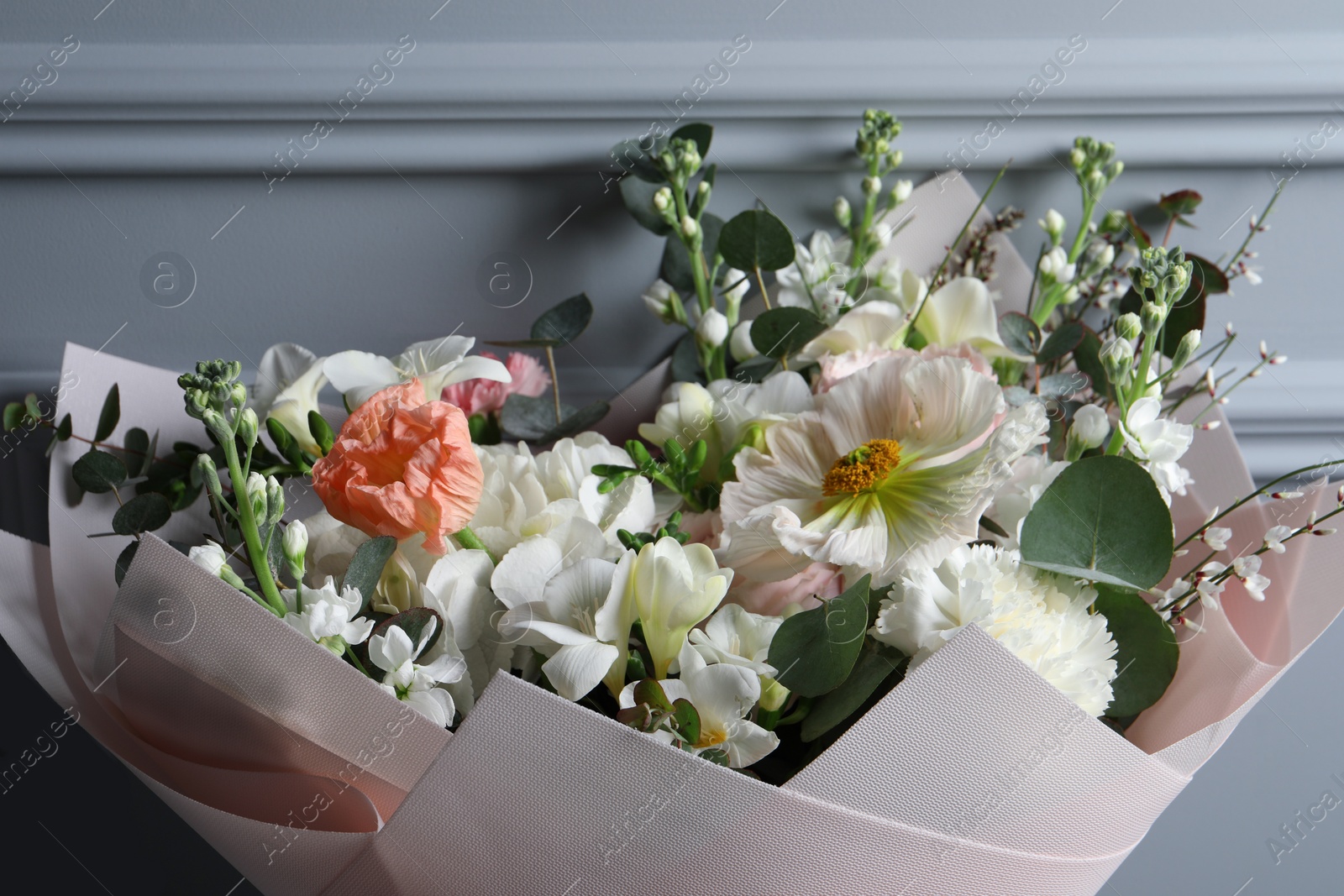 Photo of Bouquet of beautiful flowers on grey background, closeup