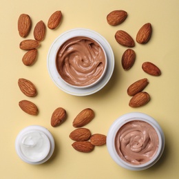 Photo of Flat lay composition with jars of body cream on beige background