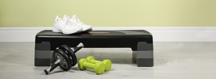 Image of Step platform and different sports equipment indoors. Banner design