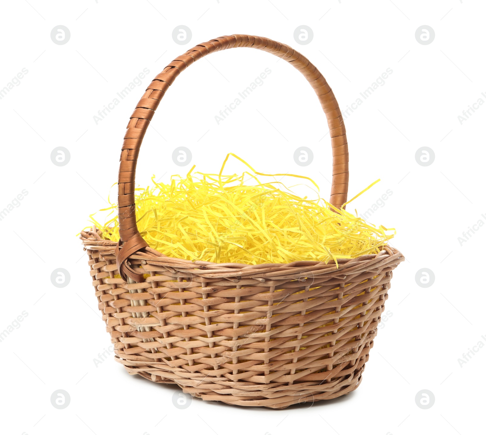 Photo of Easter basket with yellow paper filler isolated on white