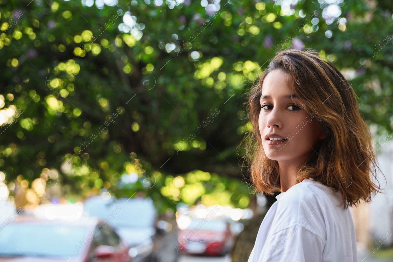 Photo of Portrait of beautiful young woman outdoors on sunny day. Space for text