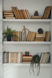 Photo of Many shelves with different decor in room. Interior design