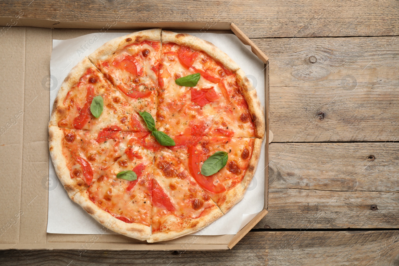 Photo of Delicious pizza Margherita on wooden table, top view