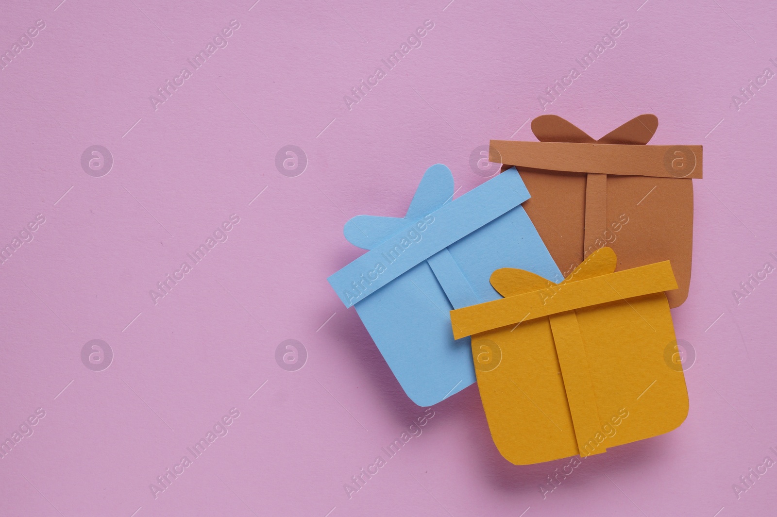 Photo of Different paper gift boxes on pink background, flat lay. Space for text