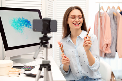 Photo of Beauty blogger filming make up tutorial at home