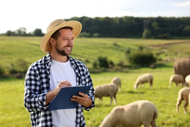 Smiling farmer with clipboard and animals on pasture