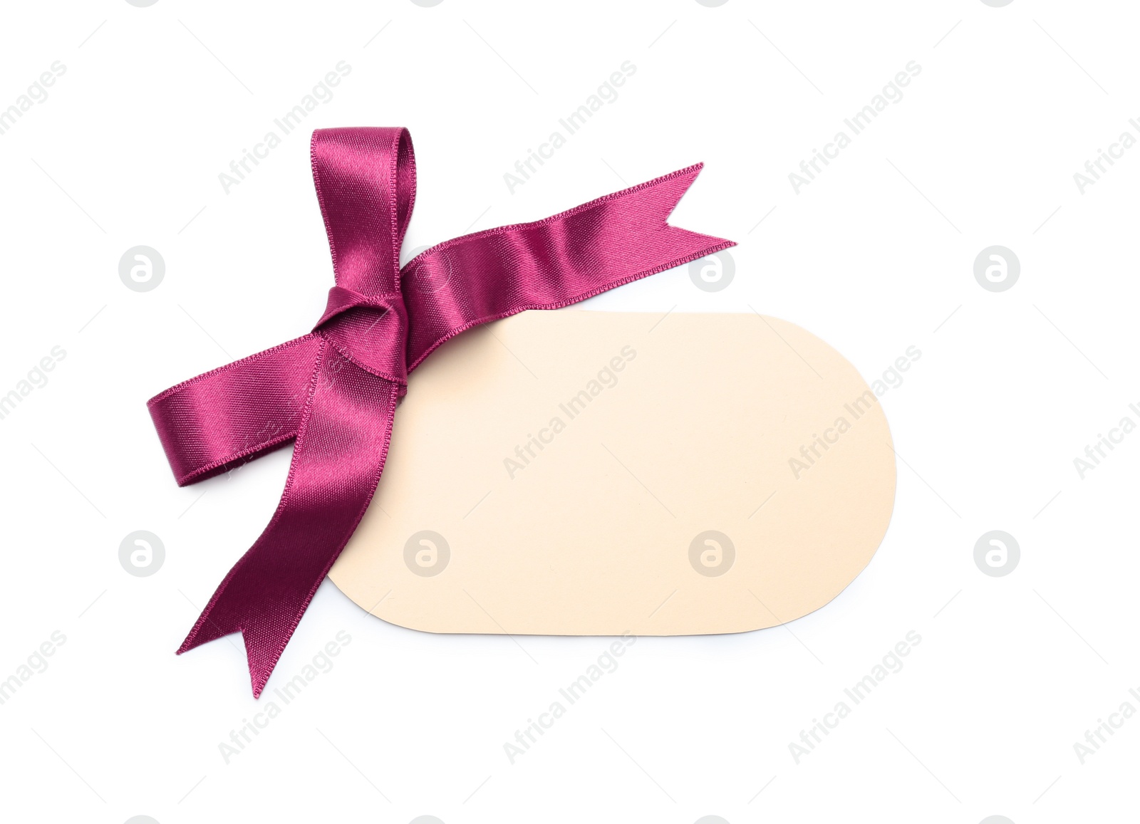 Photo of Blank gift tag with satin ribbon on white background, top view