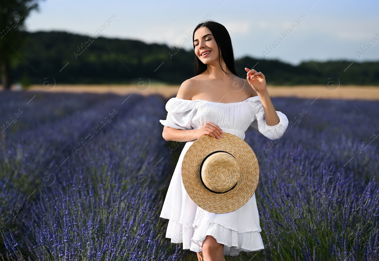 Photo of Beautiful young woman walking in lavender field