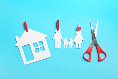 Paper silhouettes of family with pins, house and scissors on color background, flat lay. Life insurance concept