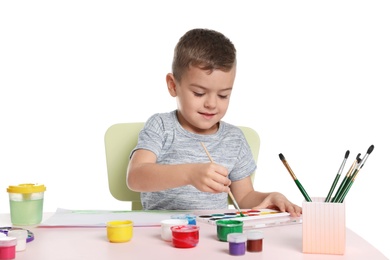 Photo of Cute child painting picture at table on white background