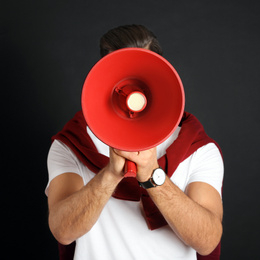 Photo of Man with red megaphone on black background
