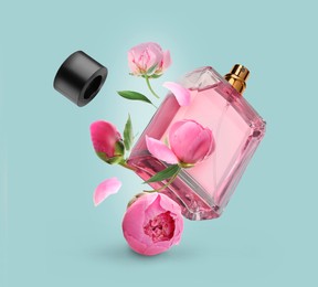 Image of Bottle of perfume and peonies in air on light blue background. Flower fragrance