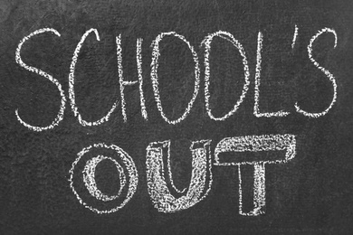 Text School's Out written on black chalkboard. Summer holidays